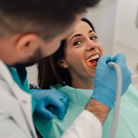 Dentist in Hays reviewing dental implant health during checkup