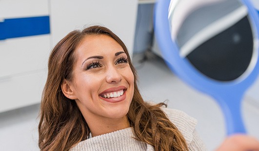 Woman smiling at reflection in mirror