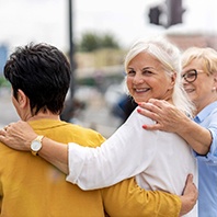 Group of women smiling while walking together outside