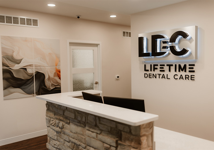 Digital sign board for Lifetime Dental Care just outside the entrance to the parking lot