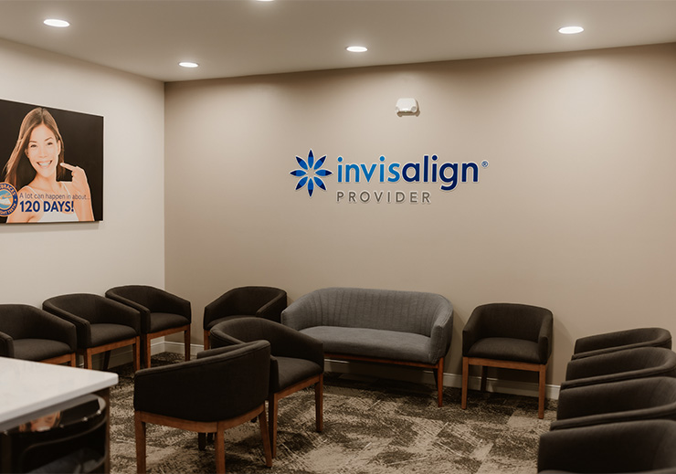 Shelf in the waiting area with plaques and other accolades for the Lifetime Dental Care team