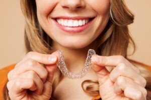 Woman putting in her clear aligner